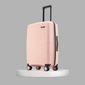 Peach medium check-in suitcase with ridged pattern, side handle, and caster wheels