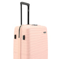 Medium check-in suitcase, peach with black handle, side vents, and textured shell