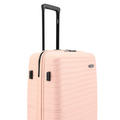 Pink medium check-in suitcase side panel with vertical vent-style grip and handle