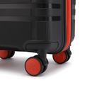 Black cabin suitcase with orange caster wheels and orange zipper edge detail