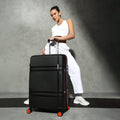 Large check-in suitcase in black with telescopic handle and four spinner wheels.
