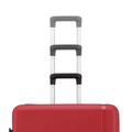 Red hard-shell luggage set with telescopic handles and ribbed shell texture