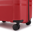 Red hard-shell suitcase with ribbed side panel, black wheel and corner bumper.