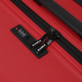 Red hard-shell luggage with black zipper pull and built-in lock panel.
