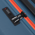 Blue suitcase zipper with orange stripe and black padlock-style access latch.