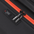 Medium check-in suitcase zipper detail, black textured shell with red zipper and black locks