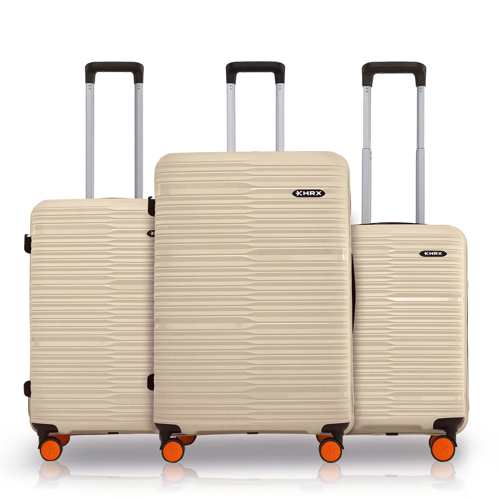 Three-piece beige luggage set with pull handles and spinner wheels