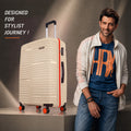 Beige hard-shell trolley suitcase with orange wheel accents and side handle