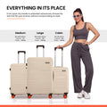 Beige medium, large, and cabin luggage stacked with 8-wheel design