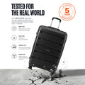 Large check-in trolley with dark finish, telescopic handle, and scuff-resistant shell