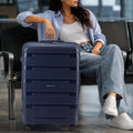 Navy check-in trolley standing on four spinner wheels with retractable handle