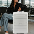 White polypropylene suitcase trolley with telescopic handle and ribbed front shell, spinner wheels