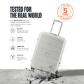 Light grey trolley suitcase with telescopic handle and tested-for-drops warranty badge