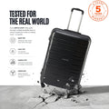 Black large trolley suitcase with four wheels and telescopic handle, with scuff marks