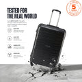 Black medium check-in trolley with telescopic handle on floor with scattered debris