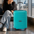 Teal 4-wheel spinner trolley standing upright with telescopic handle