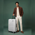 White medium check-in suitcase with ribbed shell and 8 spinner wheels, hardcase handle