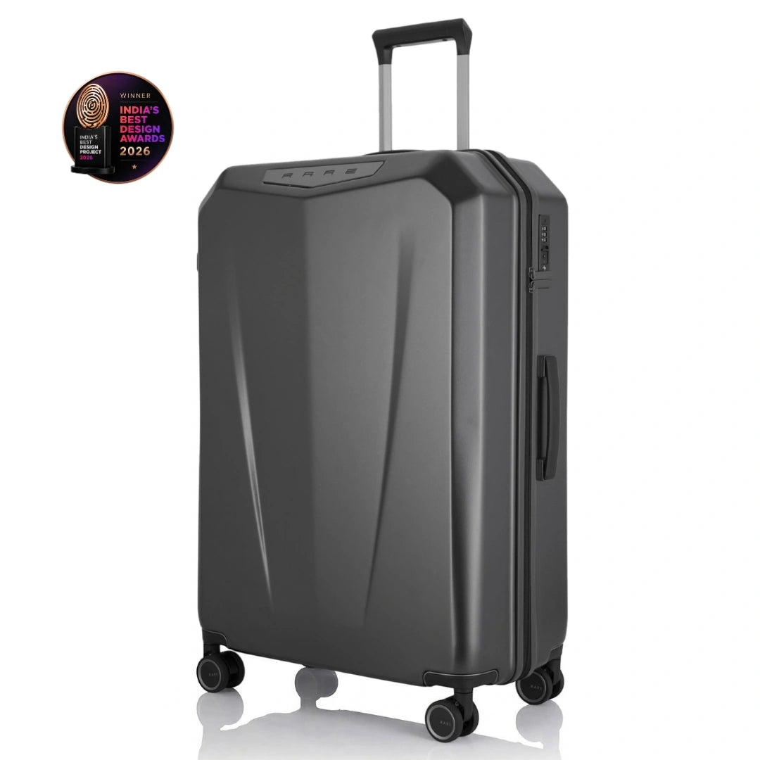 Dark grey hard-shell polycarbonate trolley suitcase, angled view, telescopic handle and wheels