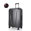 Hard-shell trolley suitcase, dark grey polycarbonate shell with telescopic handle and four wheels