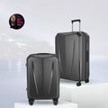 Two dark grey hard-shell polycarbonate trolley suitcases with telescopic handles and wheels