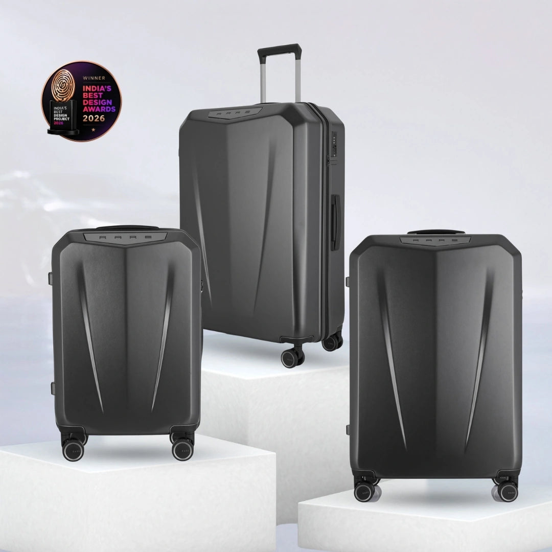 Set of three dark grey hard-shell polycarbonate trolley suitcases with telescopic handles