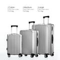 Three silver hard-shell suitcases in different sizes with spinner wheels