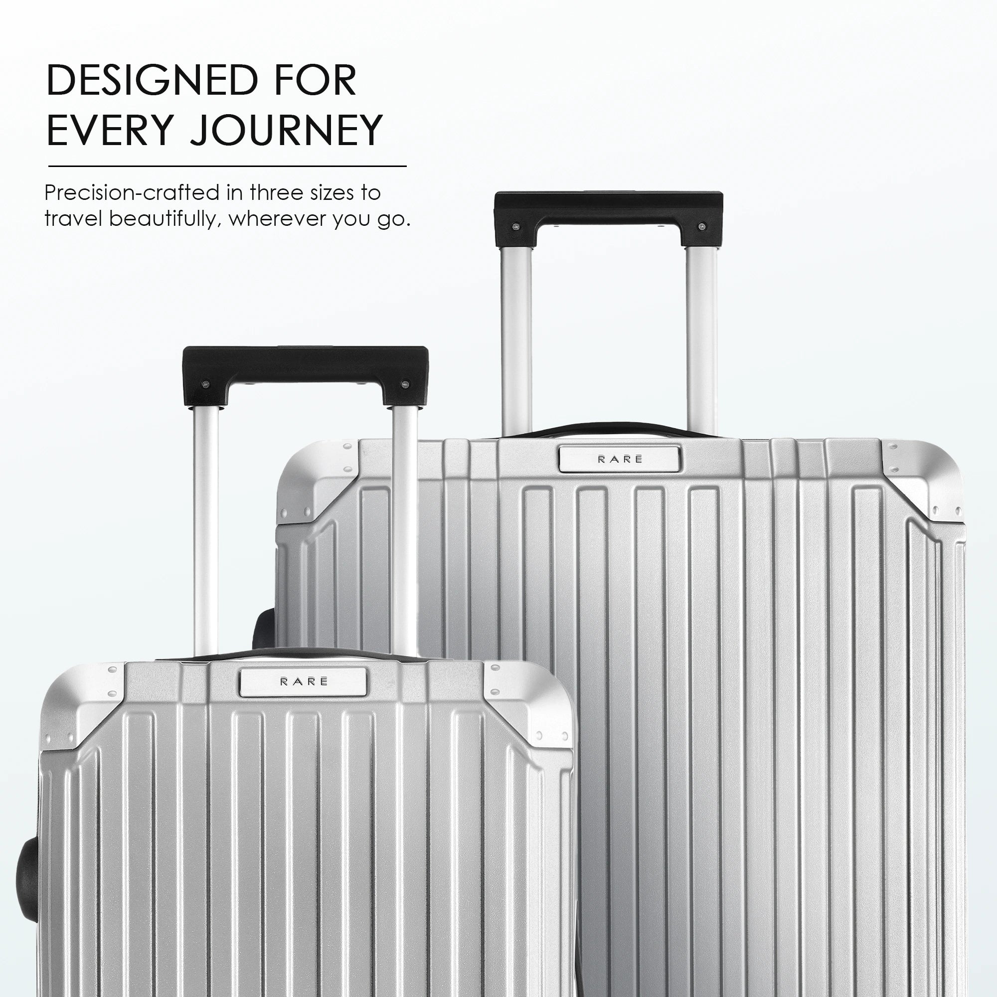 Silver polycarbonate suitcases with telescopic trolley handles and ribbed shell design