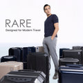 Hard-shell polycarbonate trolley suitcases in assorted dark colors, multiple sizes