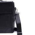 Black leather briefcase bag side with shoulder strap and metal clasp hardware
