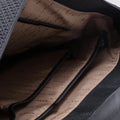 Black leather briefcase bag interior with beige lining and side pocket opening