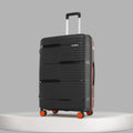 Closed large check-in suitcase in black with ridged texture, upright handle and orange wheels