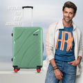 Green hard-shell check-in suitcase front view with telescopic handle and red wheels