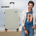 Single hard-shell suitcase, light grey with orange wheels, standing upright with logo front