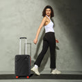 HRX small cabin suitcase, black shell with telescopic handle and red-trim wheel accents