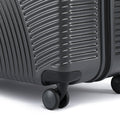 Hard-shell rolling luggage with 8 wheels, close-up of textured shell and rolling wheels