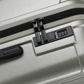 Silver suitcase zipper track with number lock keypad and recessed handle panel