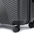 Charcoal gray suitcase wheel with ribbed hard-shell panel and side zipper track detail