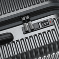 Suitcase zipper and combination lock on charcoal ribbed shell.