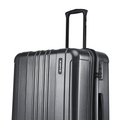 Charcoal gray suitcase close-up with ribbed shell, telescopic handle, and front lock area