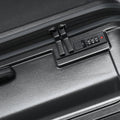 Large check-in suitcase side lock panel with combination dial on dark grey shell