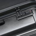 Charcoal hard-shell suitcase with recessed zip pull and combination lock panel