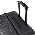 Large check-in suitcase corner with telescopic handle and recessed grip on black shell