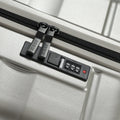 Silver suitcase zipper track with integrated combination lock panel and pull tabs