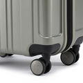 Silver small cabin suitcase showing corner wheels and lower side latch, hard-shell design