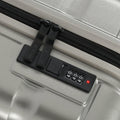 Small cabin suitcase built-in 4-digit code lock on silver front panel.