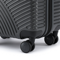 Charcoal grey hardshell suitcase corner with 2 caster wheels and textured ridges