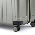 Close-up of hard-shell suitcase corner and 360-degree wheels with cover