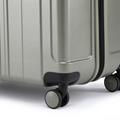Metallic green hard-shell suitcase corner with 8 spinner wheels and protective base