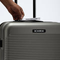 HRX silver-gray suitcase handle area with hand pulling a luggage tag