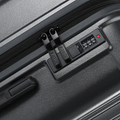 Charcoal grey suitcase close-up of TSA-style lock panel and zipper track